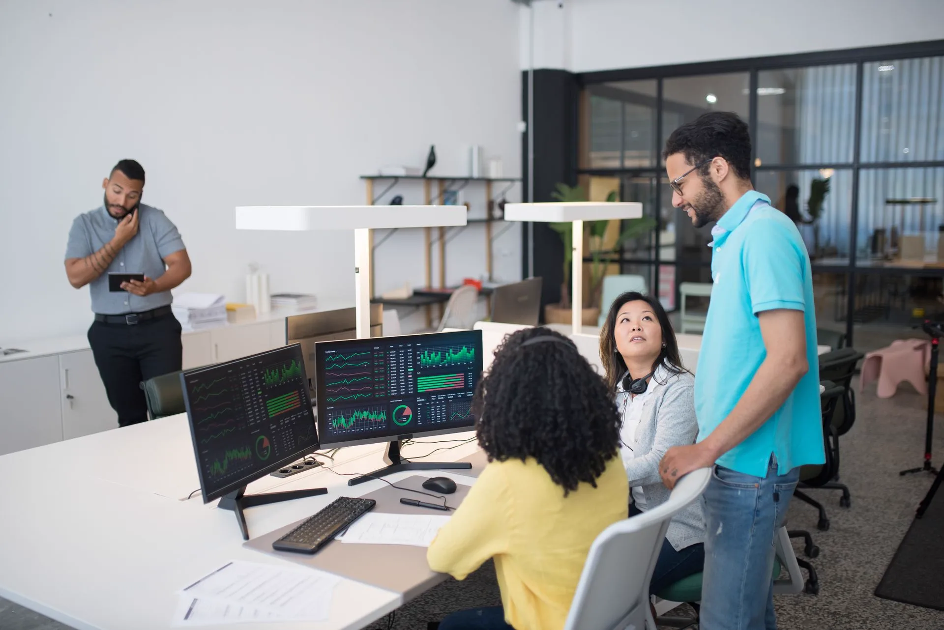 Colleagues collaborating together in a modern, bright office